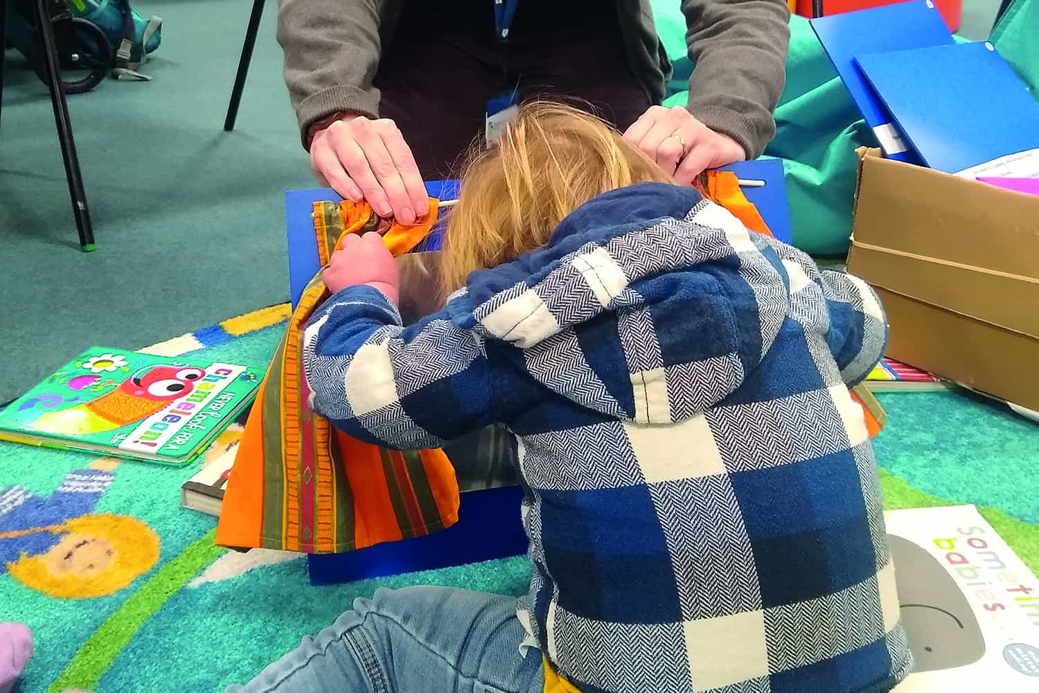 Pix of pre-school children playing and reading books in library