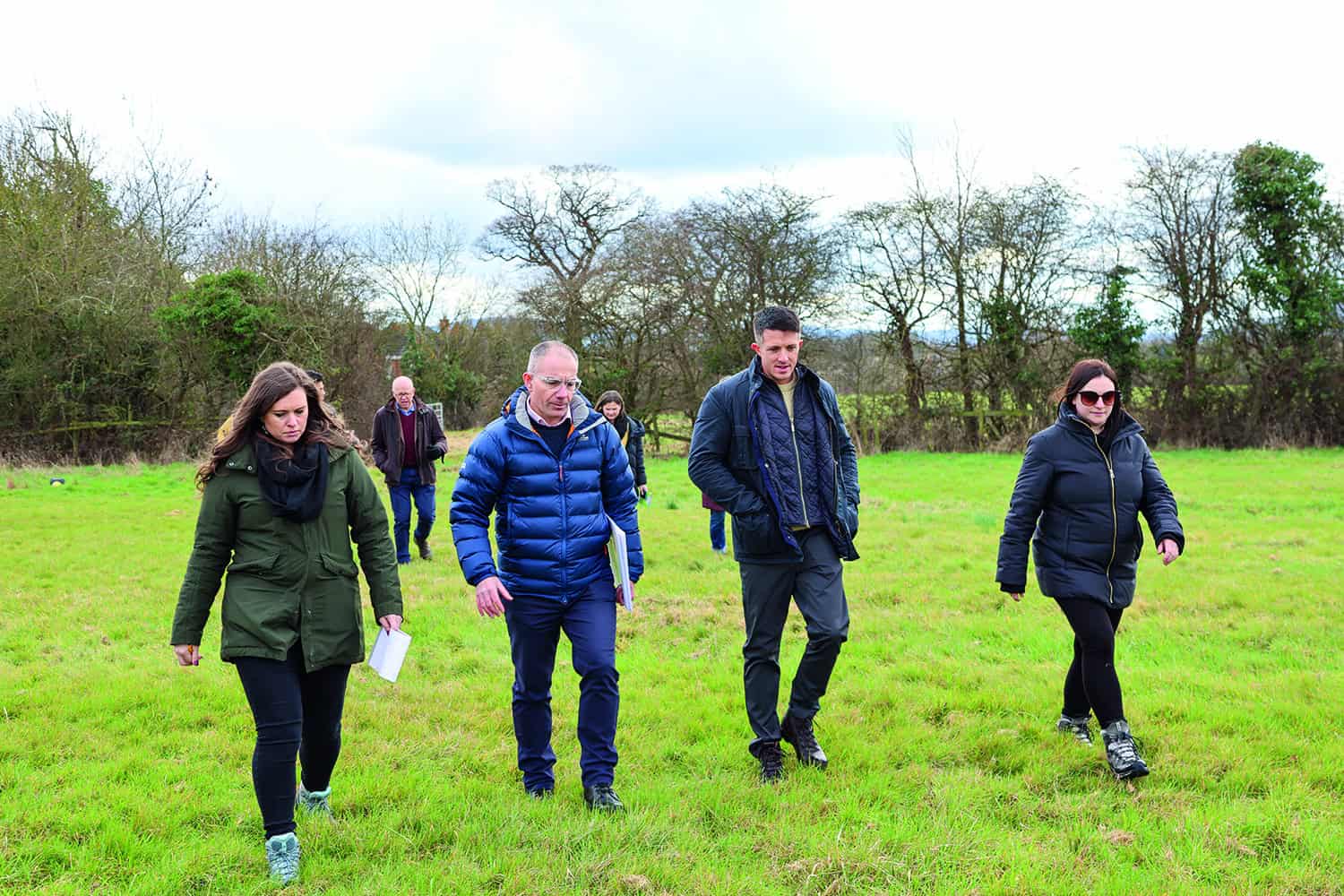 The LG Challenge contestants walking across a field.