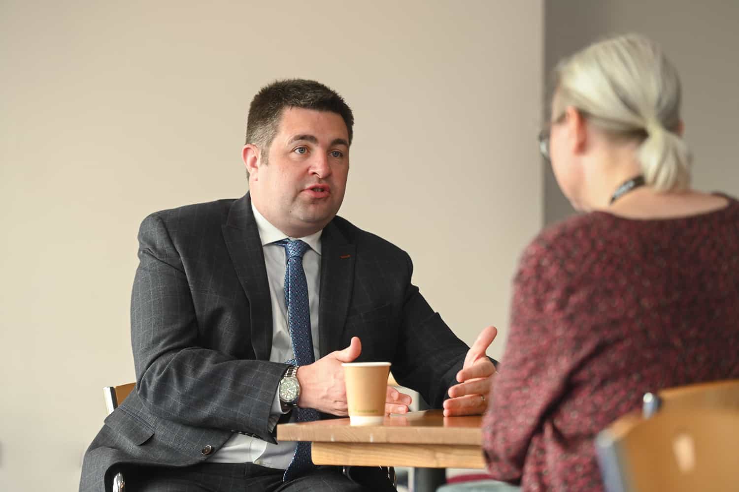 photo of LGA Chair Cllr Shaun Davies sitting at a table being interviewed