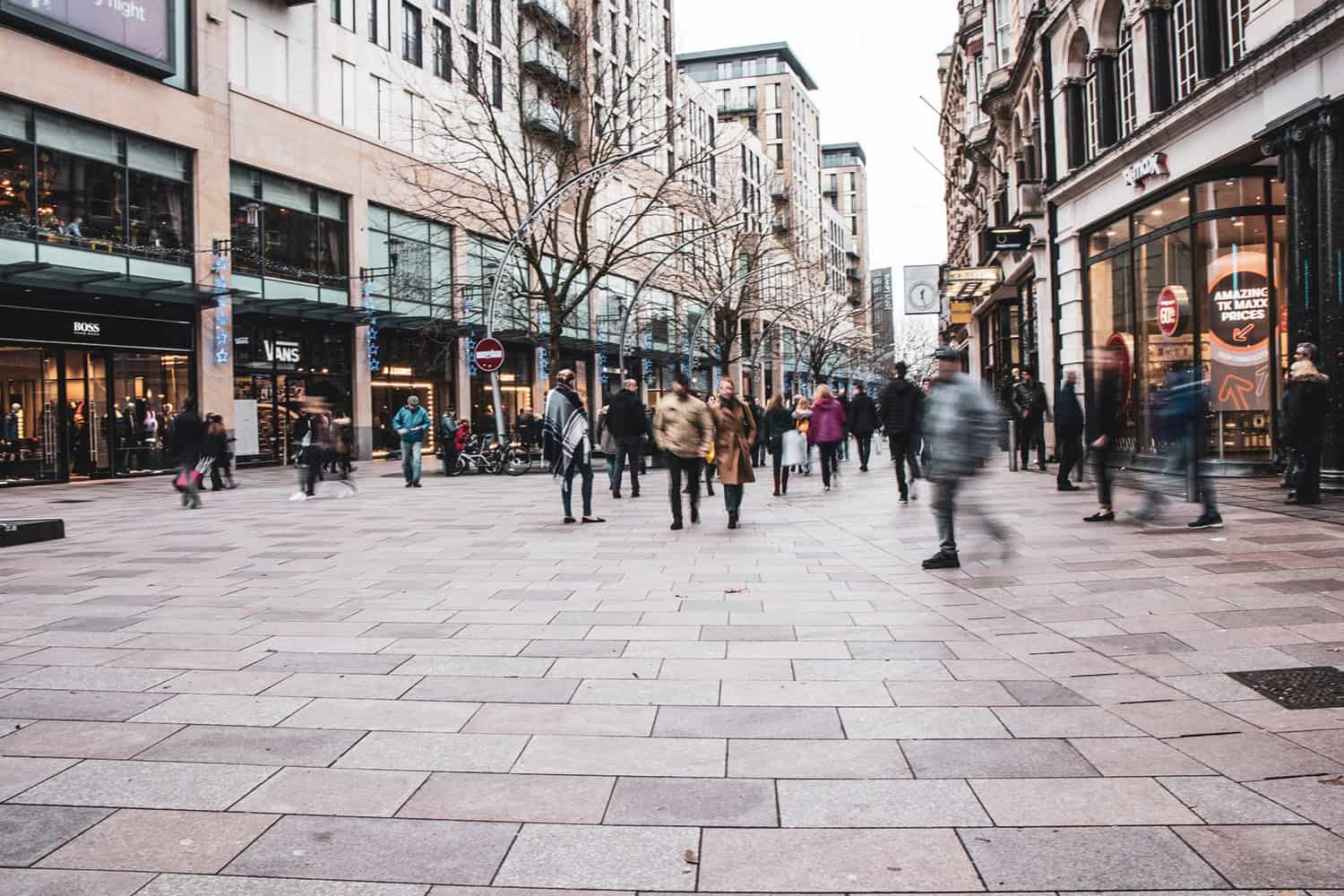 Pedestrians outside shops in Cardiff