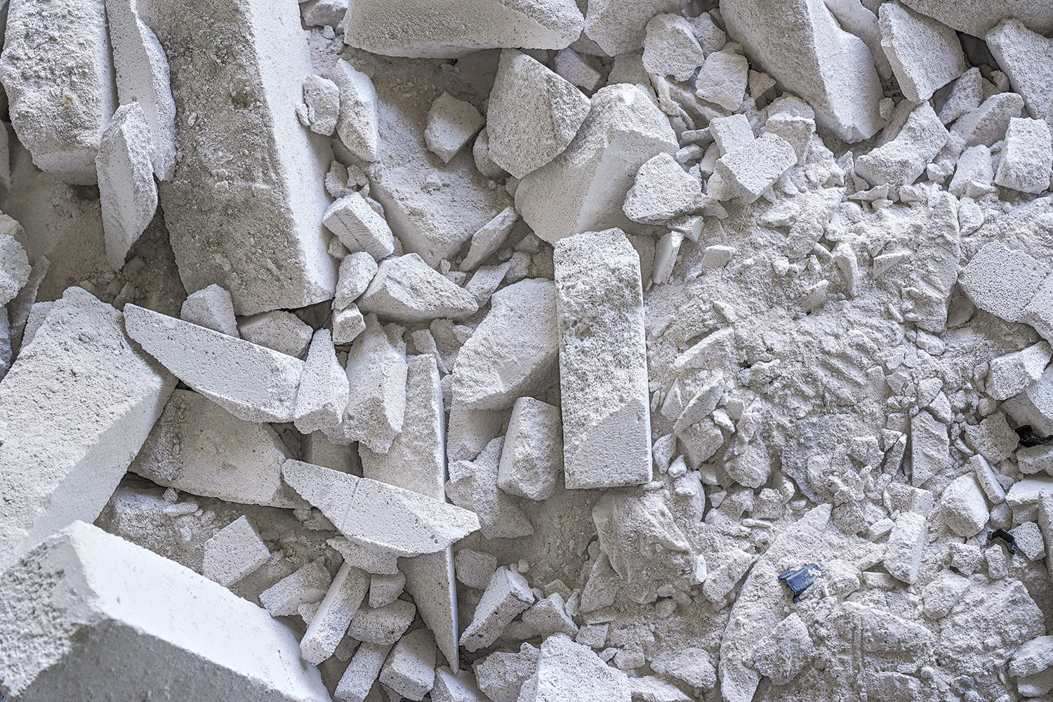 A large pile of broken, white concrete slabs.