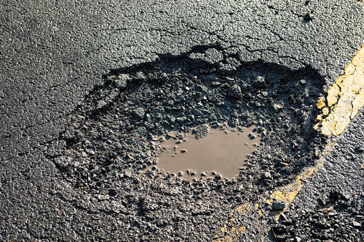 A large pothole in the road.