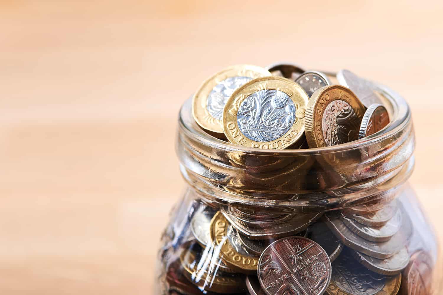 A jar filled with pound coins.