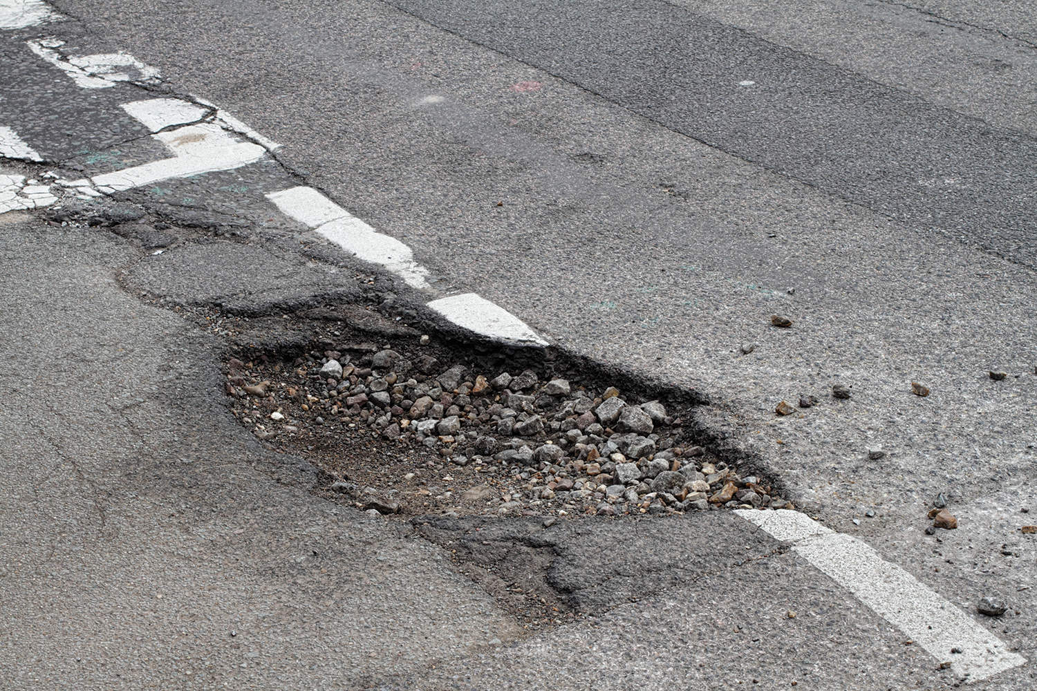 A large pothole in a road.