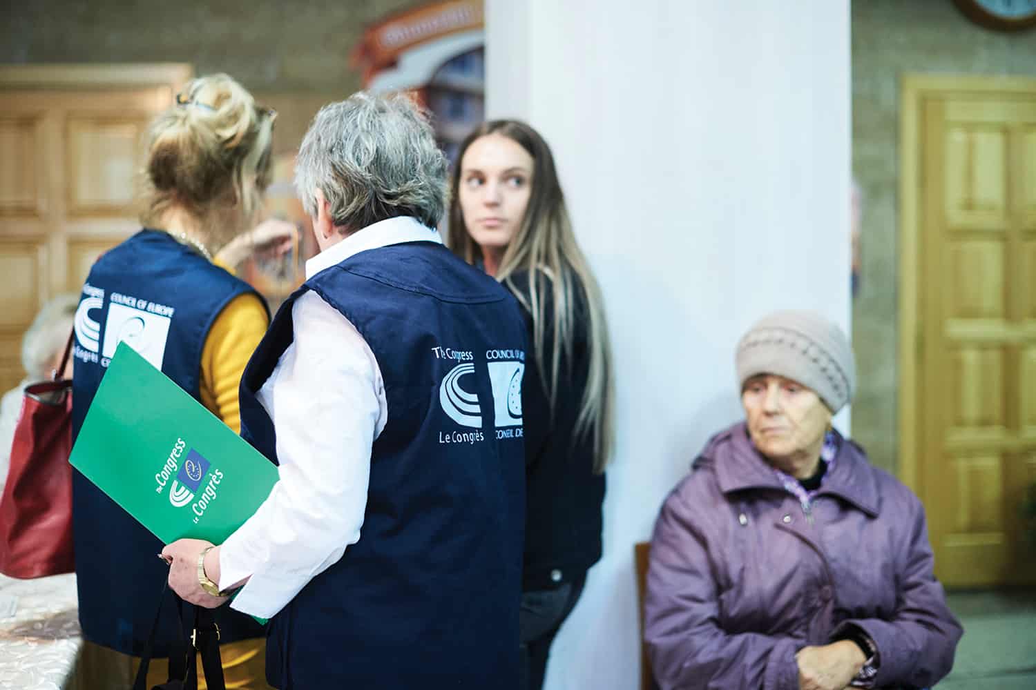 A member of the EU Congress holding a folder with the congress logo