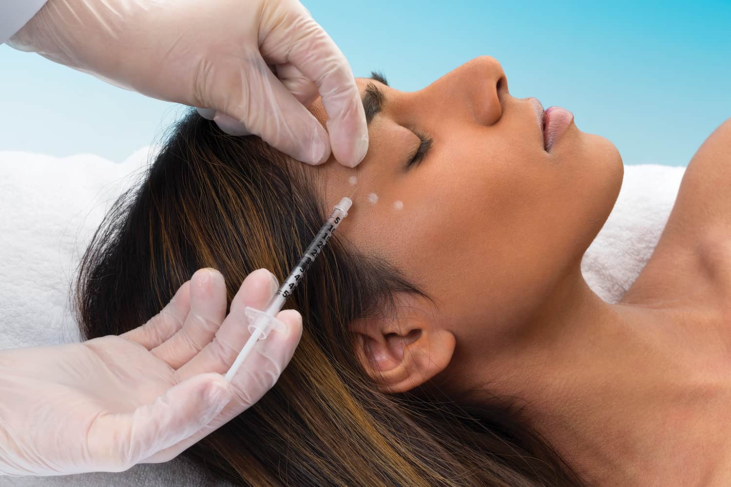 A young woman receiving an injection for a cosmetic procedure