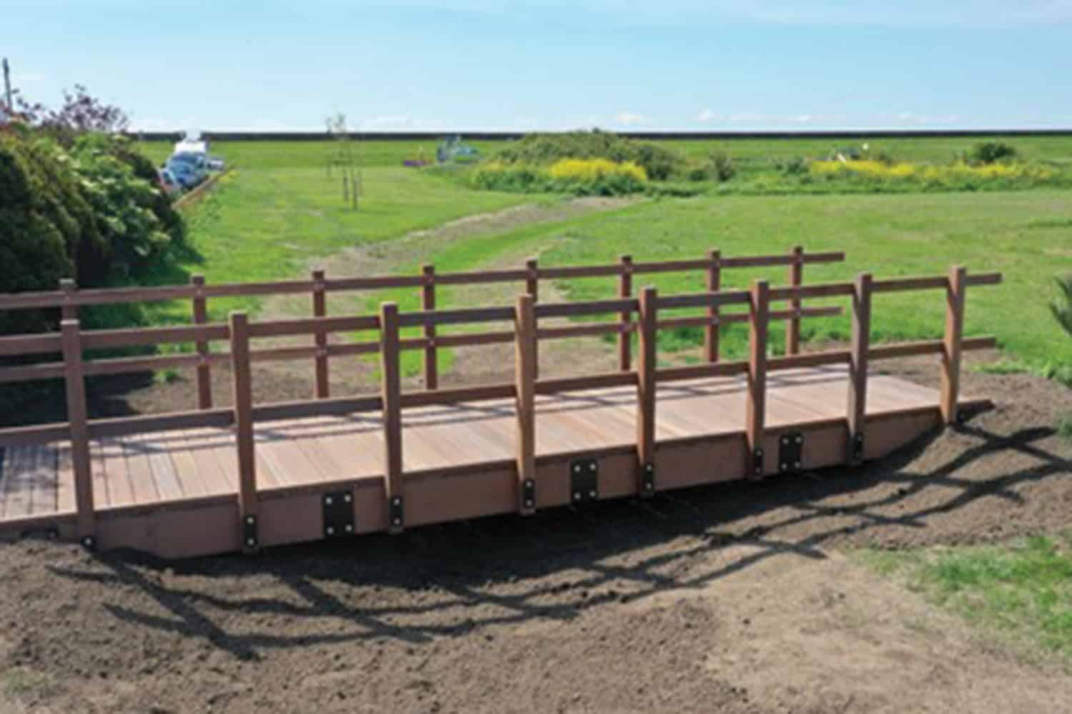 photo of footbridge over a swale at Park Avenue, Canvey Island, Essex; and of teachers sat around a classroom table in a Luton school discussing a climate action project