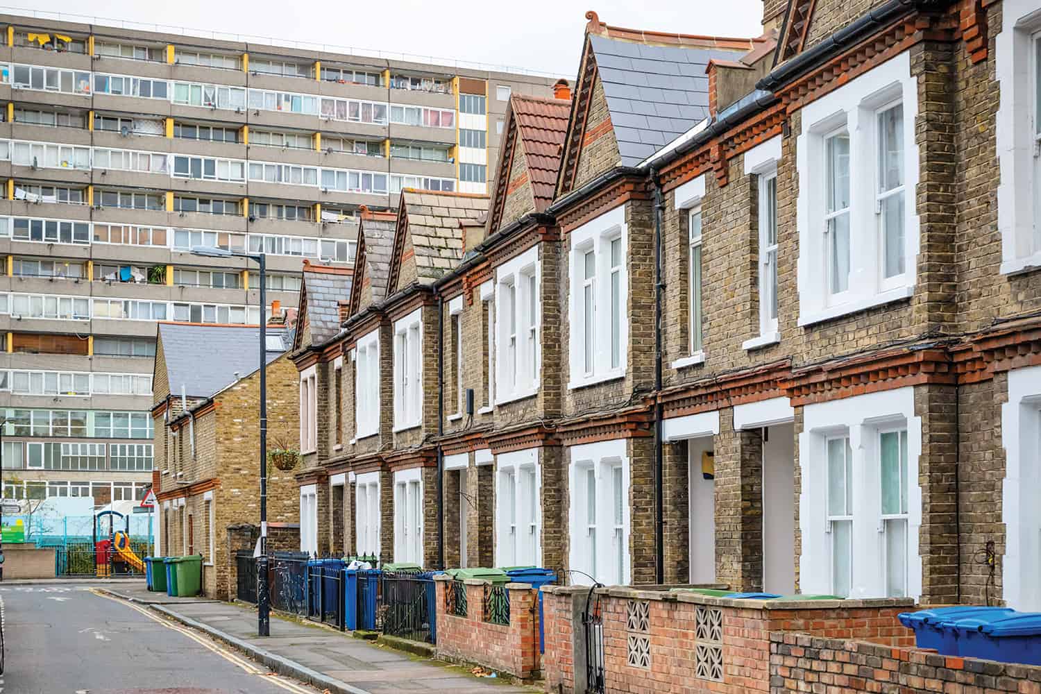 photo of street of terrace housing with large block of flats behind