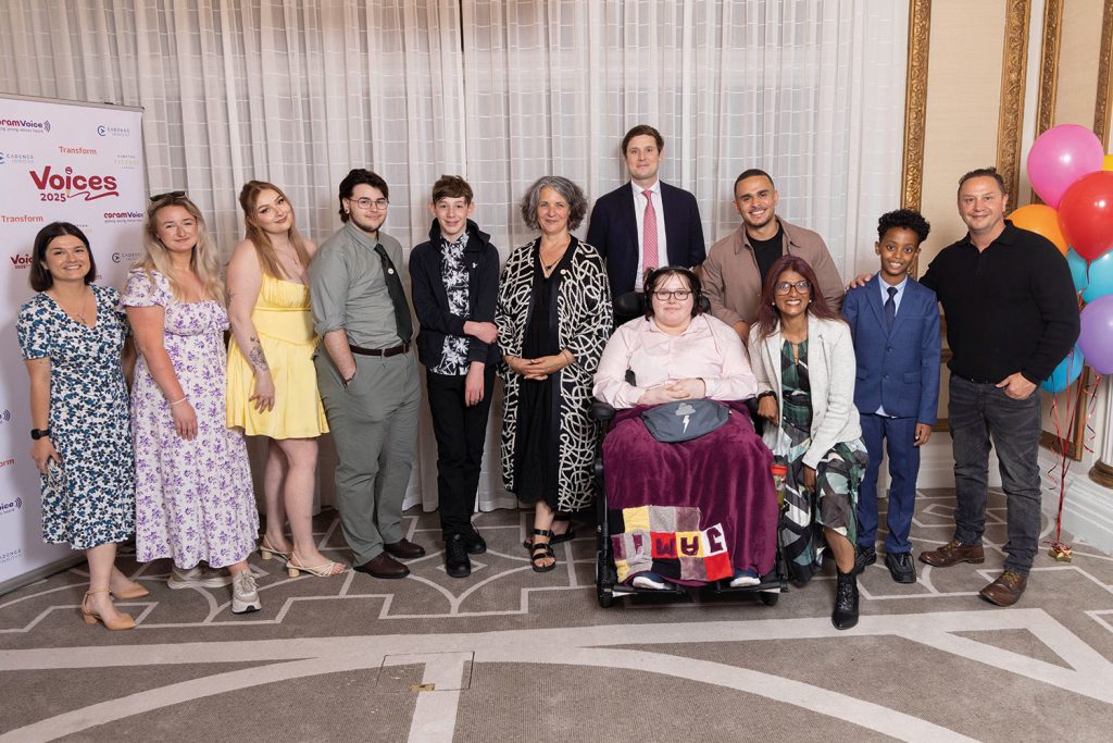 Host Ashley John-Baptiste (third from right, standing) with winners, judges and supporters of
Voices 2025