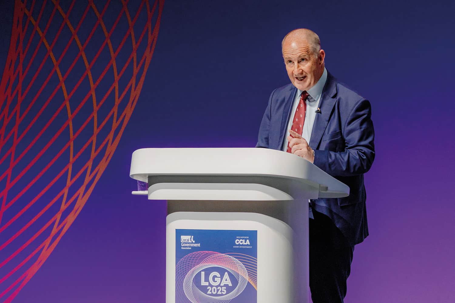 photo of Shadow Communities Secretary Kevin Hollinrake speaking on stage at a podium at the LGA’s annual conference in Liverpool, copyright LGA/Joe Outterside)