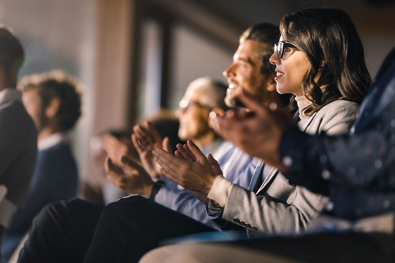 photo of people applauding at a conference