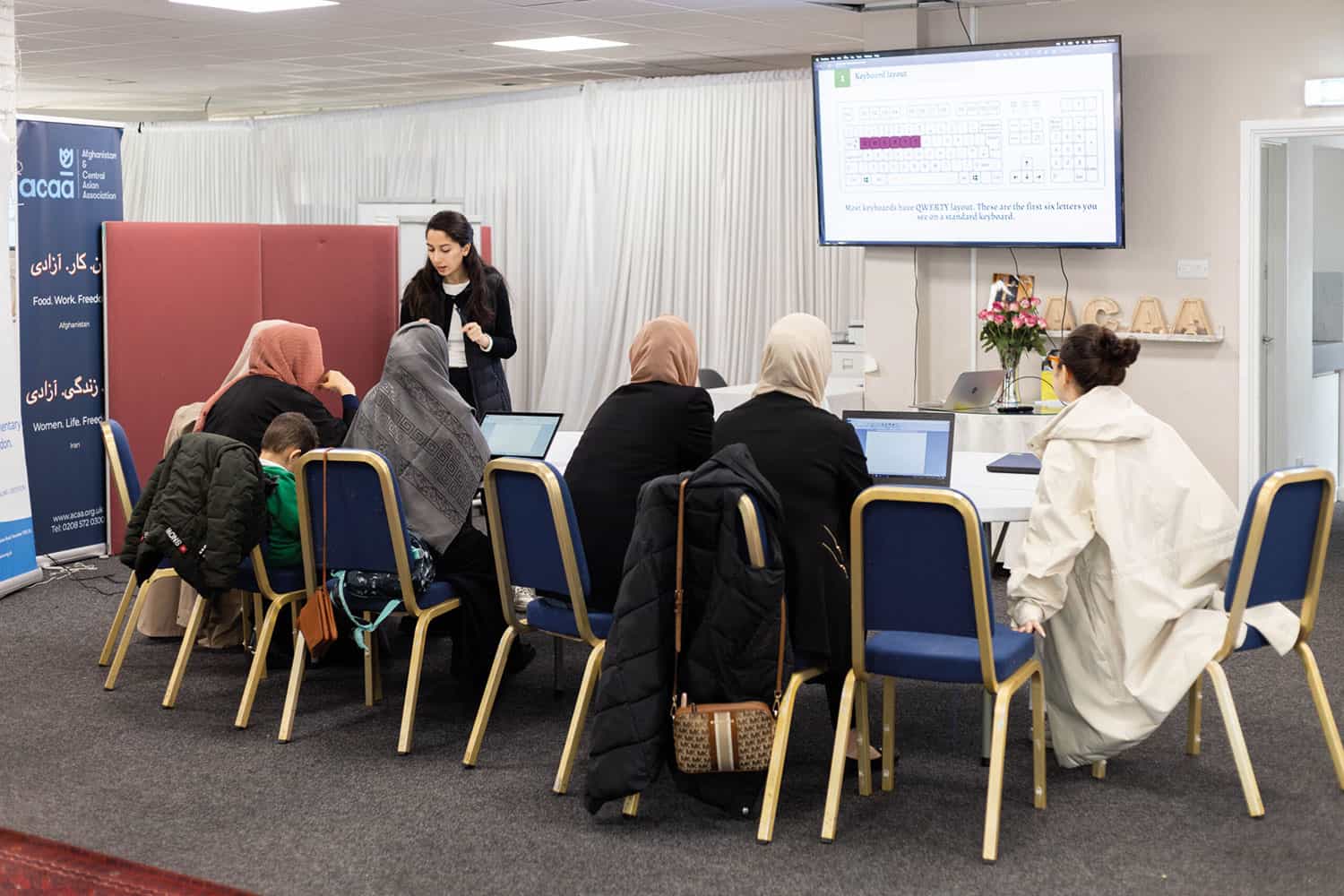 women using laptops at a support group run by the Afghanistan and Central Asian Association