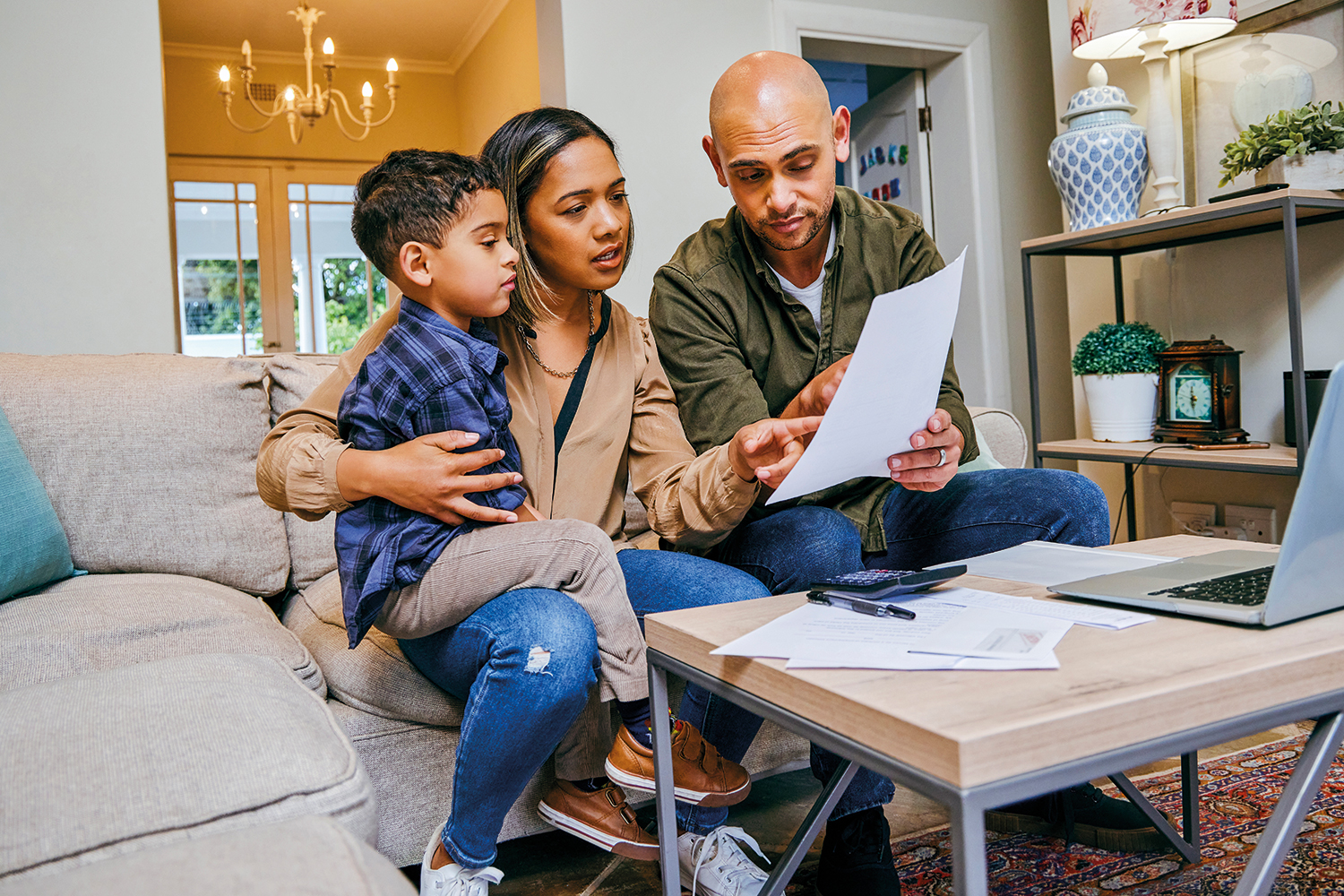 couple sitting with young son looking at paperwork