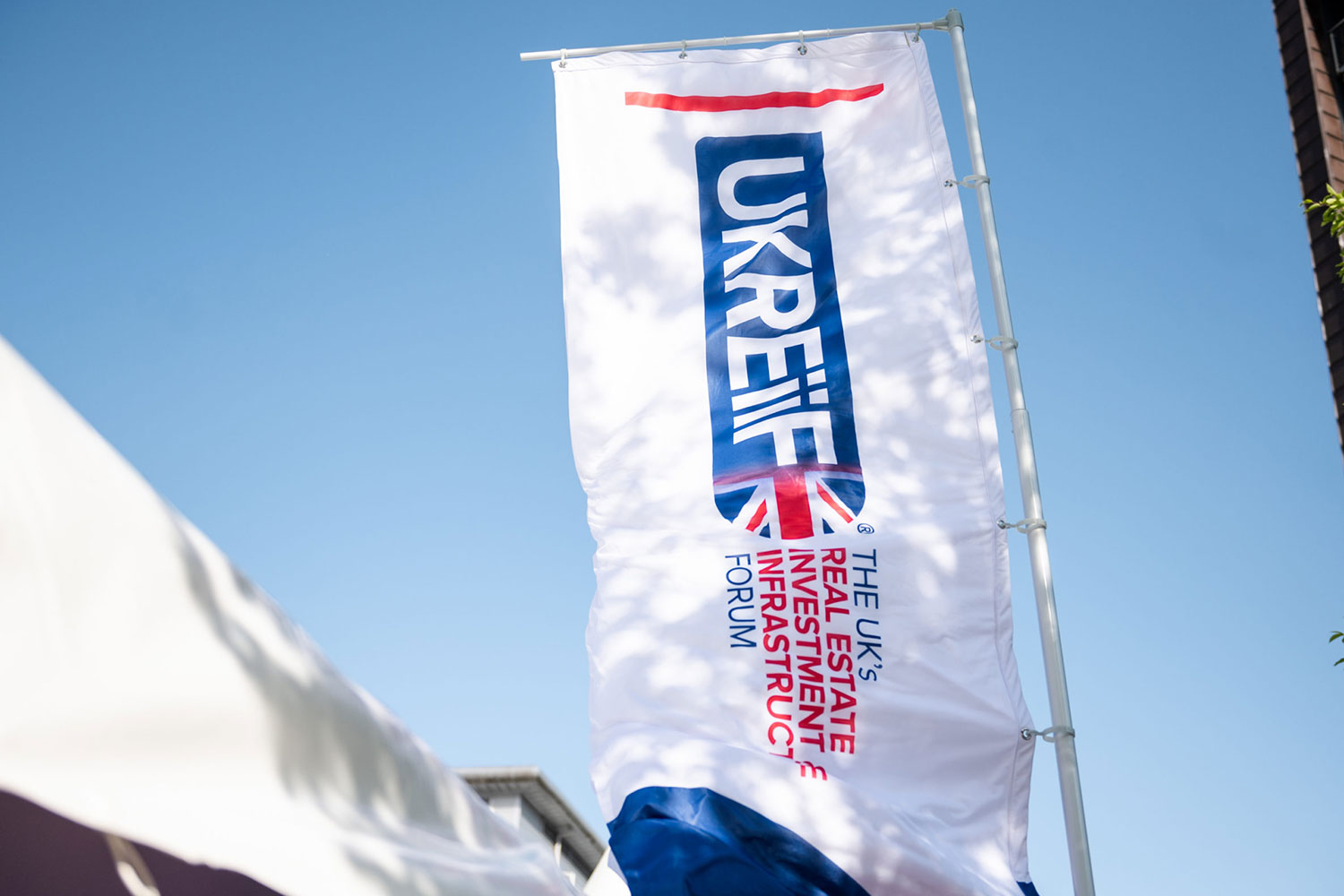 vertical photo of UKREiiF banner flying at UKREiiF conference in Leeds,