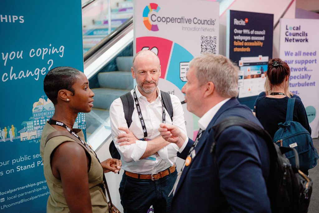 delegates chatting in front of exhibition stands