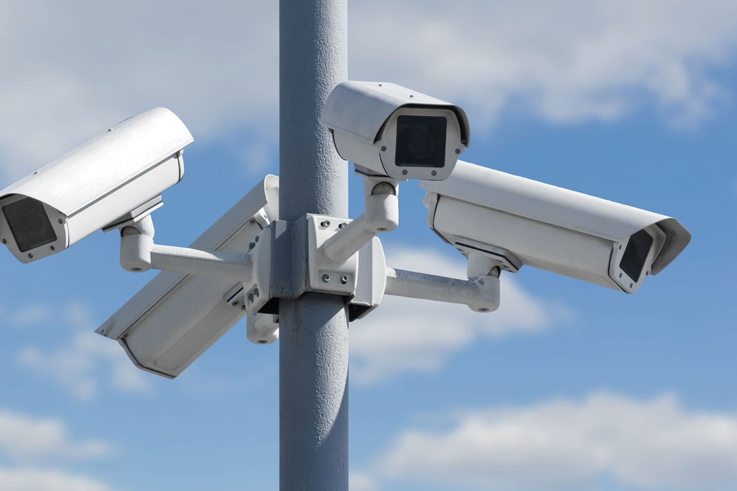 photo of close-up of cluster of four white cameras on a pole