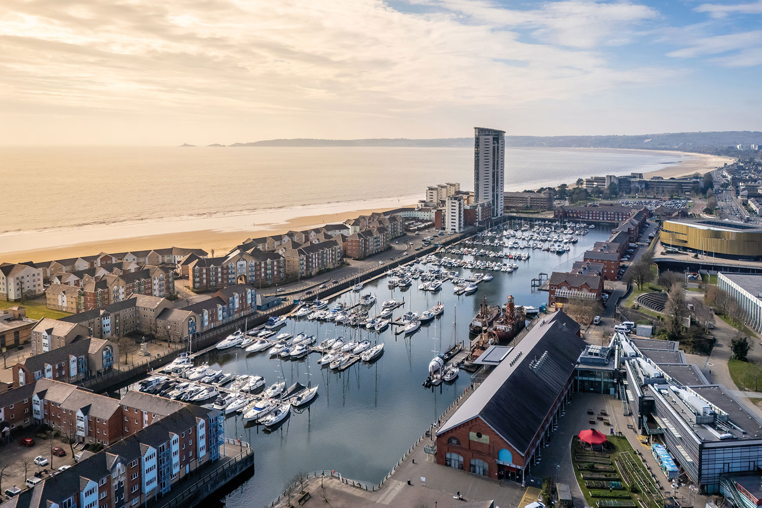 photo from above of Penarth marina, south Wales, with beach, sea and land curving away in the background